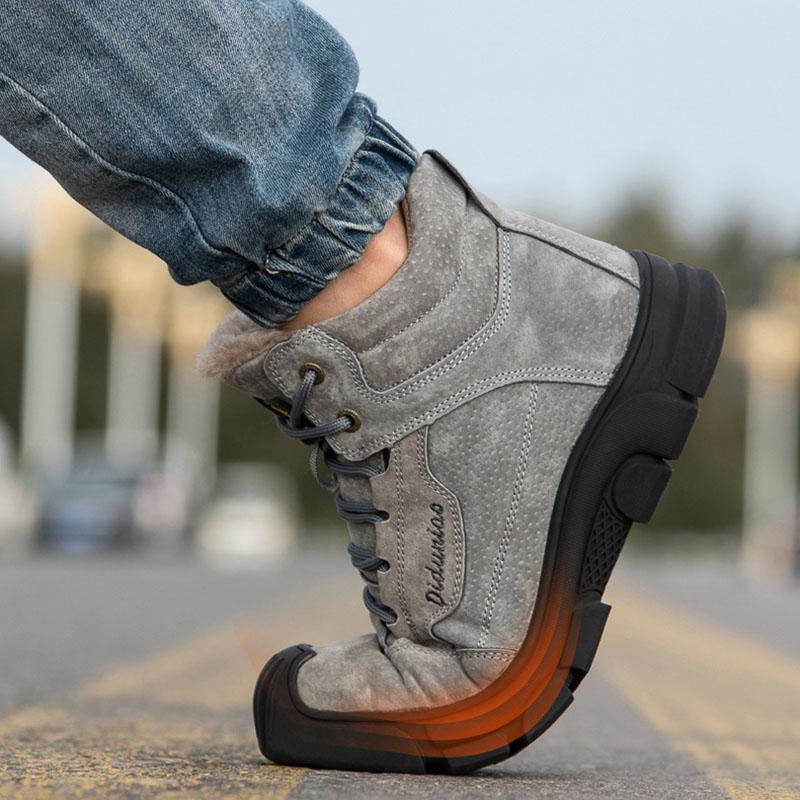 Pair of grey men's safety shoes on a plain background