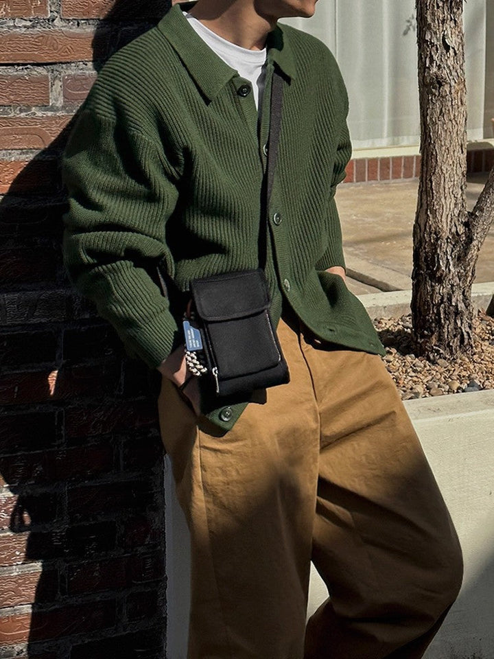 Men's cardigan displaying its ribbed texture and pointed collar