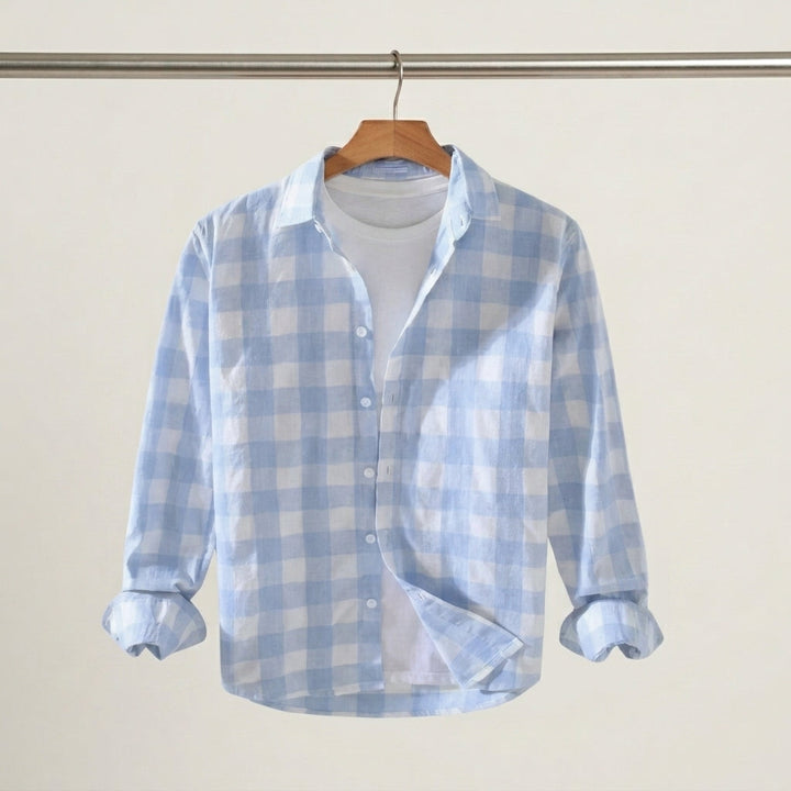 Button fastening and collar detail on a men's check shirt