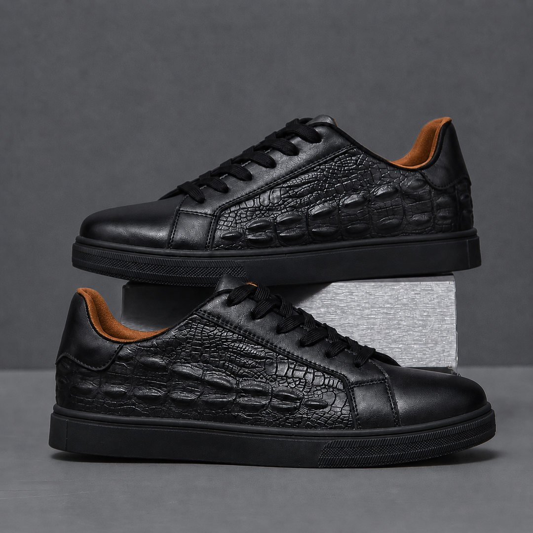 Pair of textured leather sneakers positioned together on a plain background