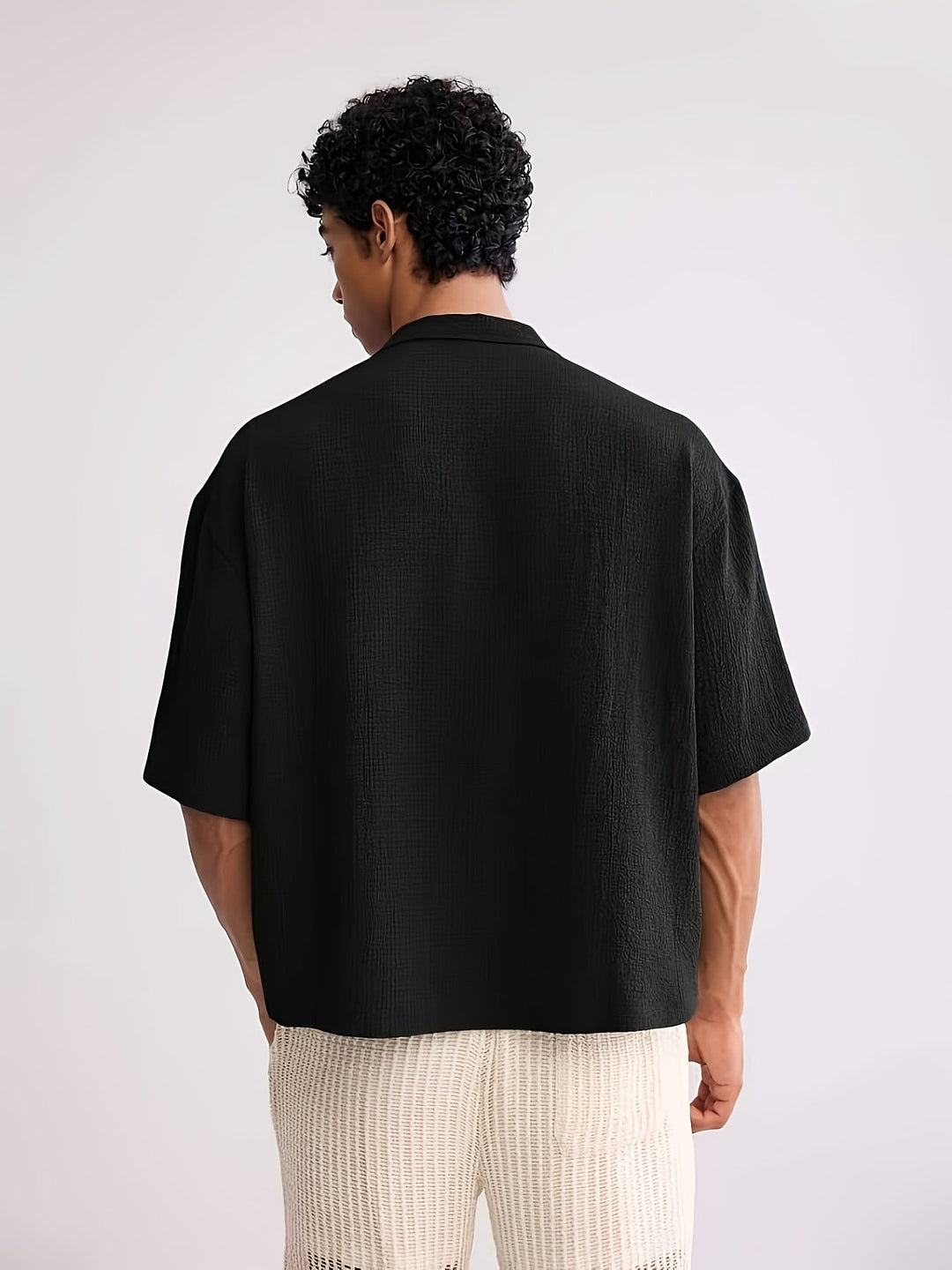 Close-up of the camp collar and front buttons on the men's shirt