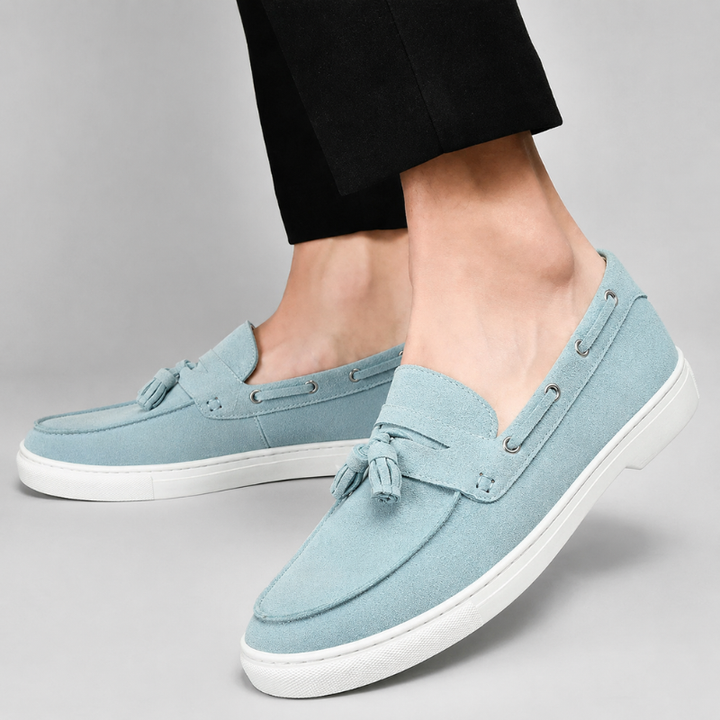Men's suede tassel loafers side profile showing tassel detail and slip-on shape