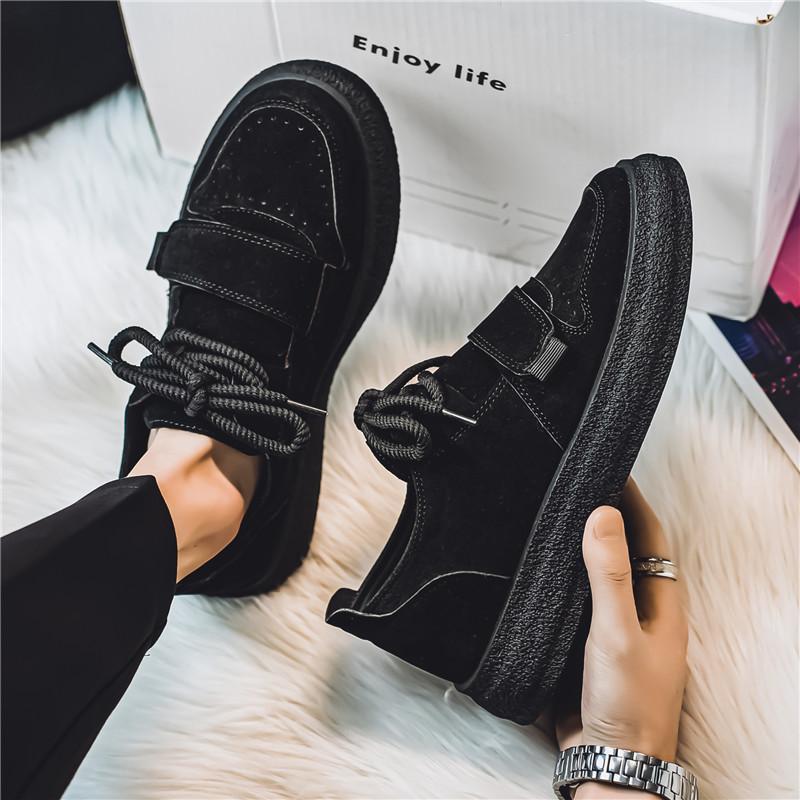 Pair of men's suede trainers photographed against a plain background