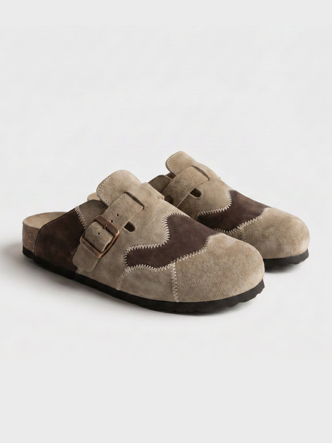 Men's beige suede clogs angled to show the sole and shape