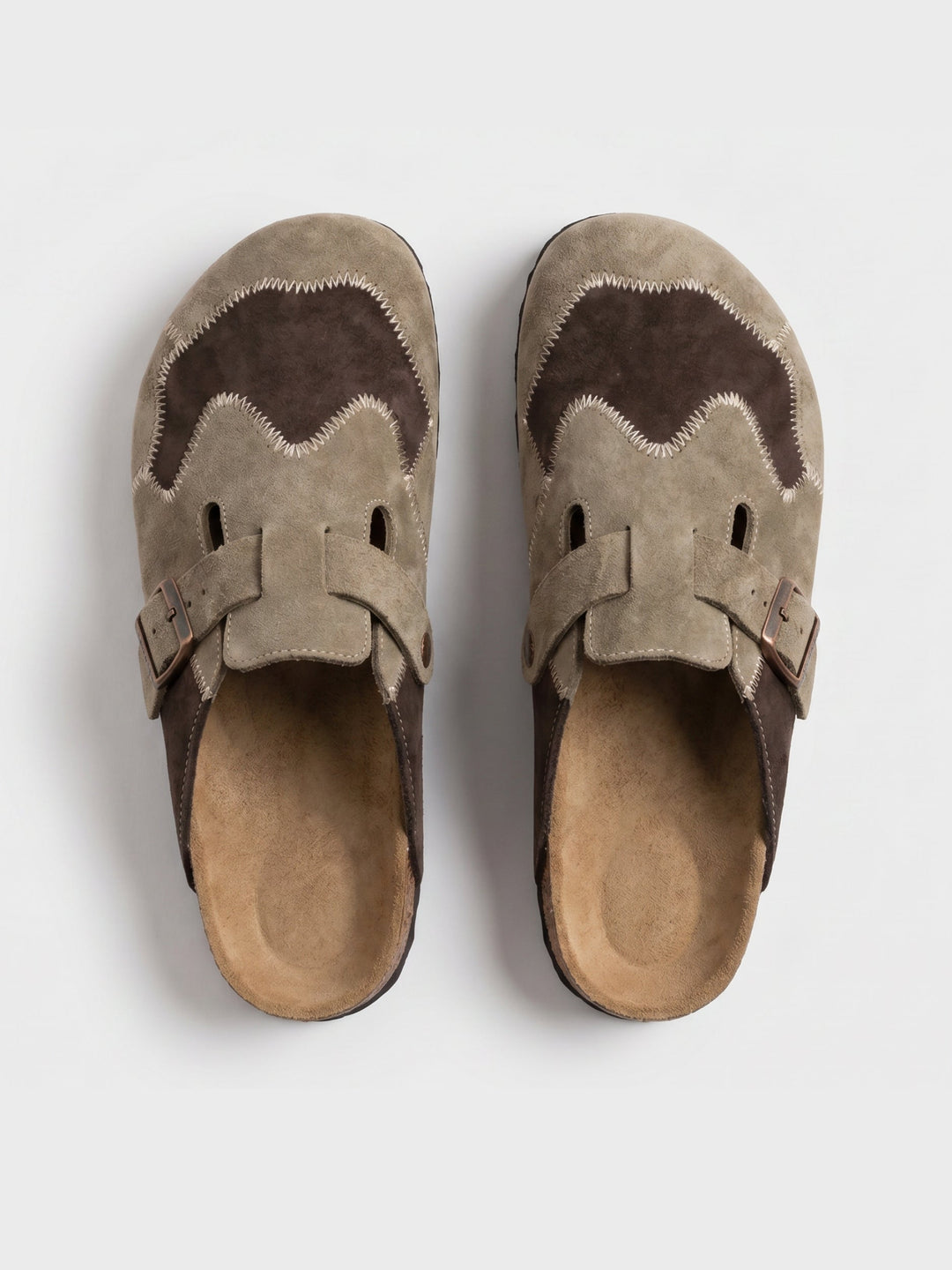 Pair of men's beige suede clogs on a clean white background