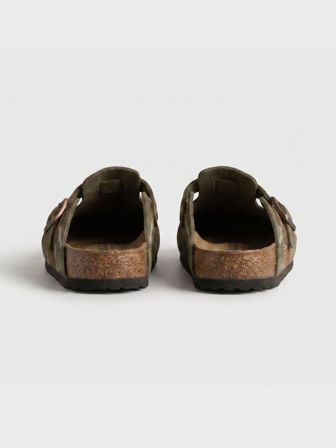 Detail view of men's slip-on clogs in beige suede