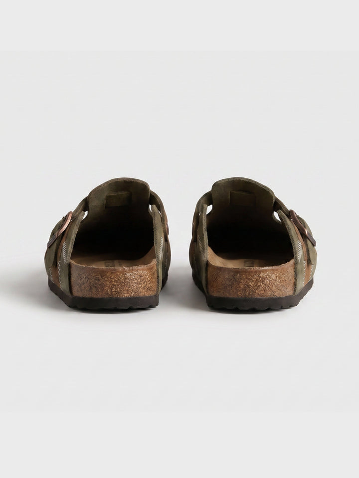 Detail view of men's slip-on clogs in beige suede