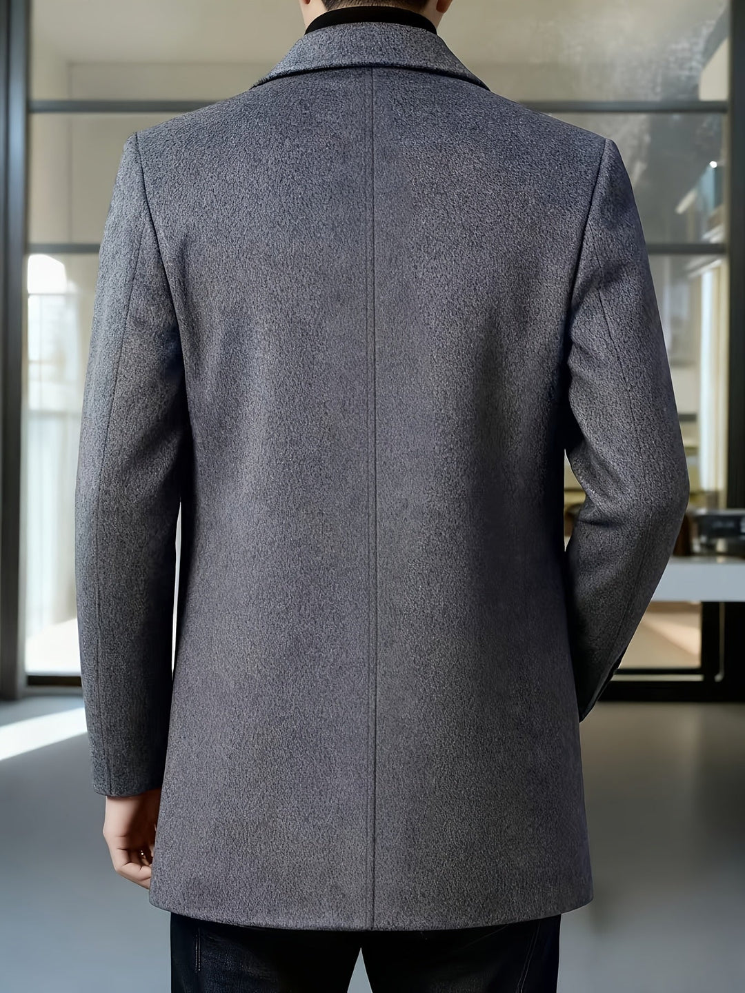 Men's long coat displaying its smart single-breasted front