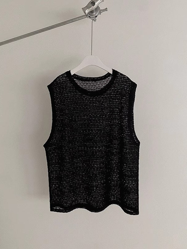 Men's open knit vest styled on a model with casual trousers