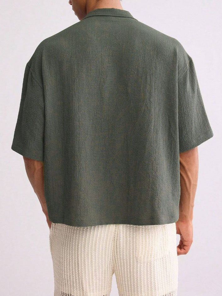 Men's short-sleeve shirt with camp collar and button front, close-up