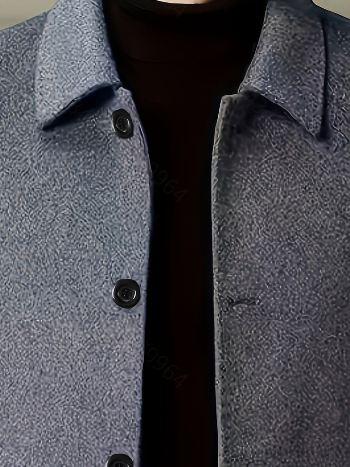 Close-up of the long coat's tailored lapel and front fastening