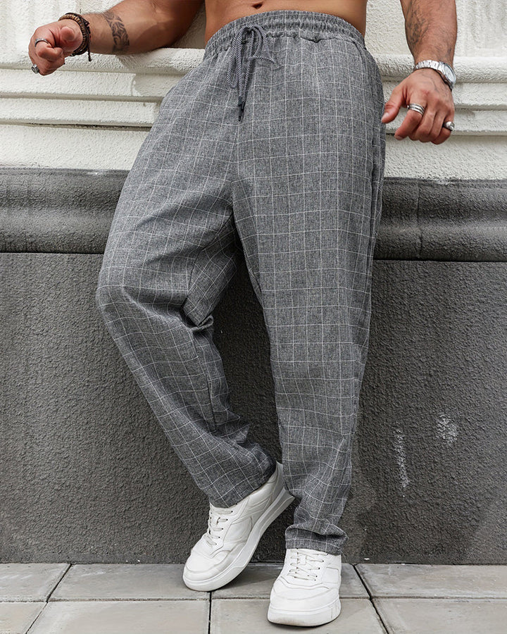 Detail view of men's straight leg plaid trousers with pocket styling