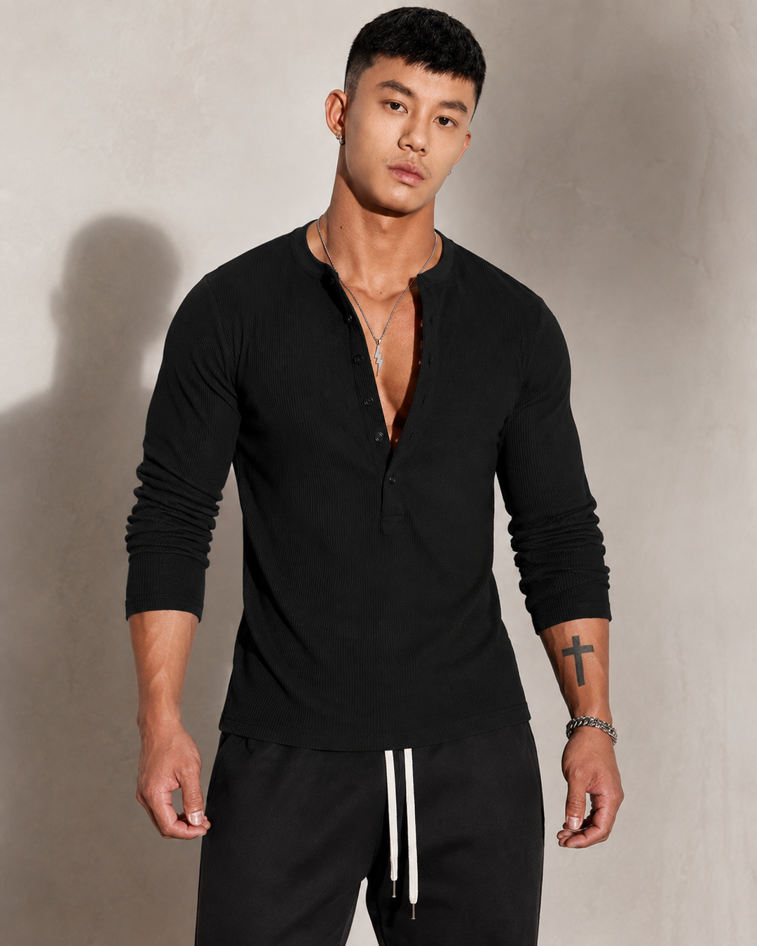 Men's jumper showing the button fastening at the collar