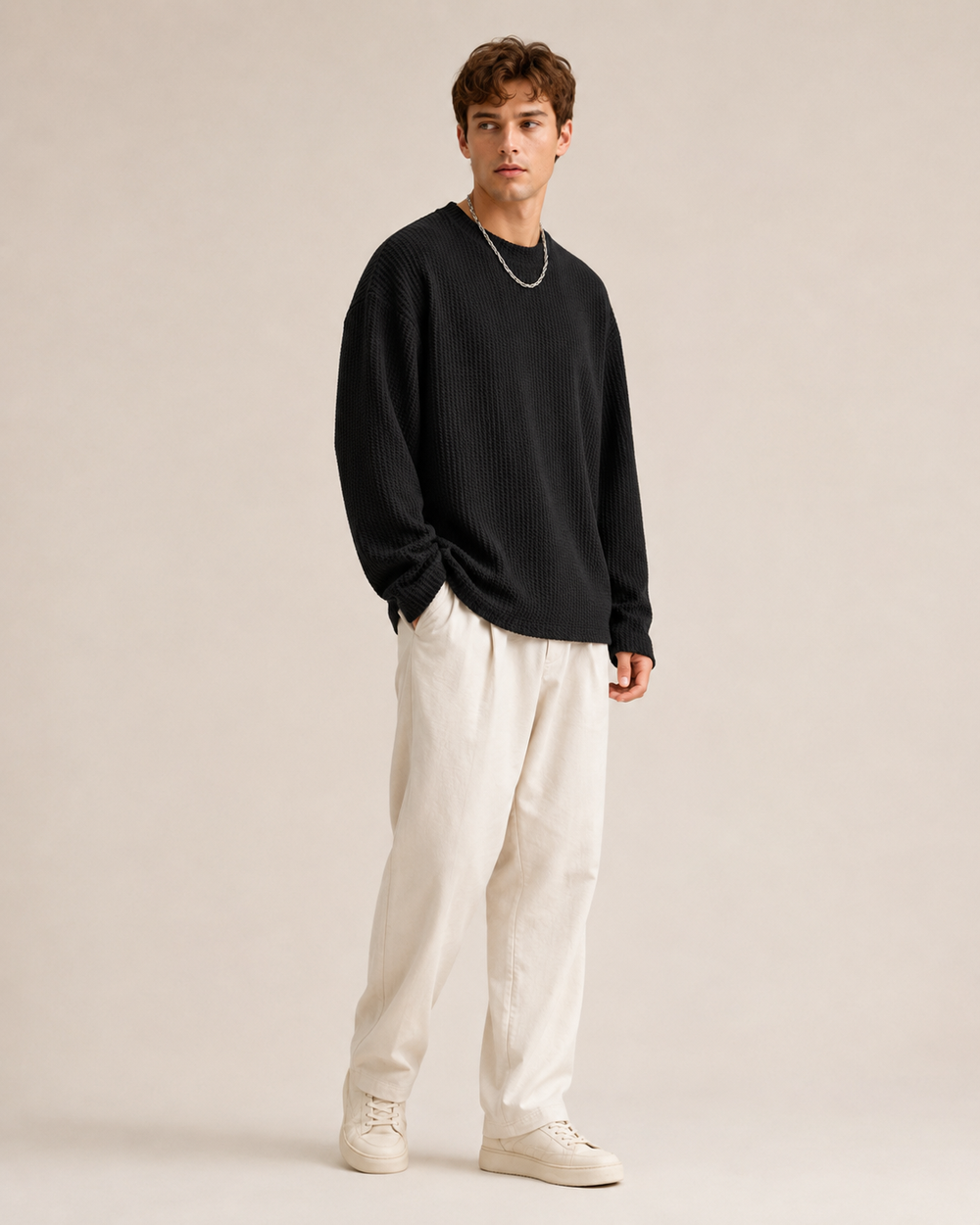 Men's pullover displaying its waffle texture and relaxed fit