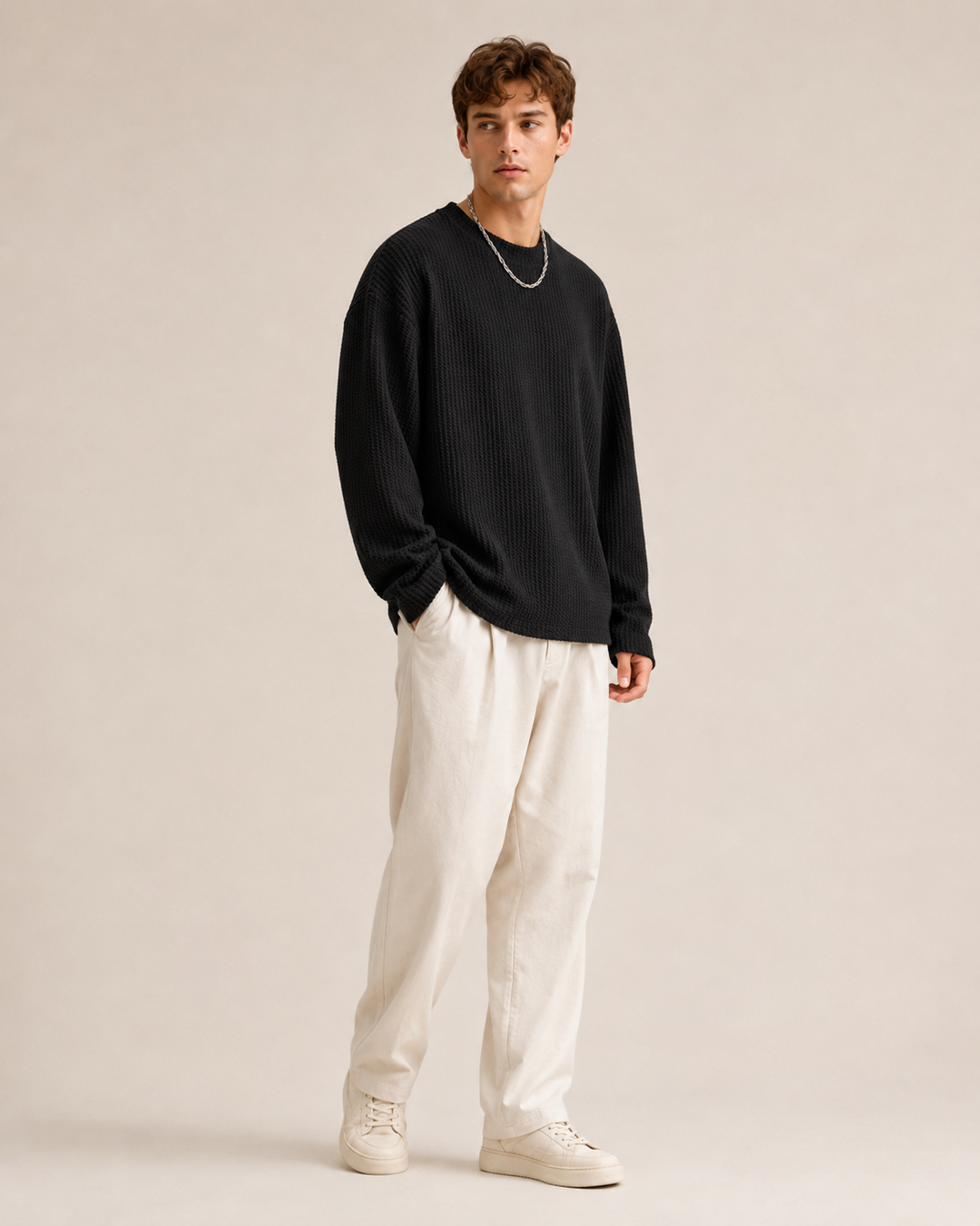Men's pullover displaying its waffle texture and relaxed fit