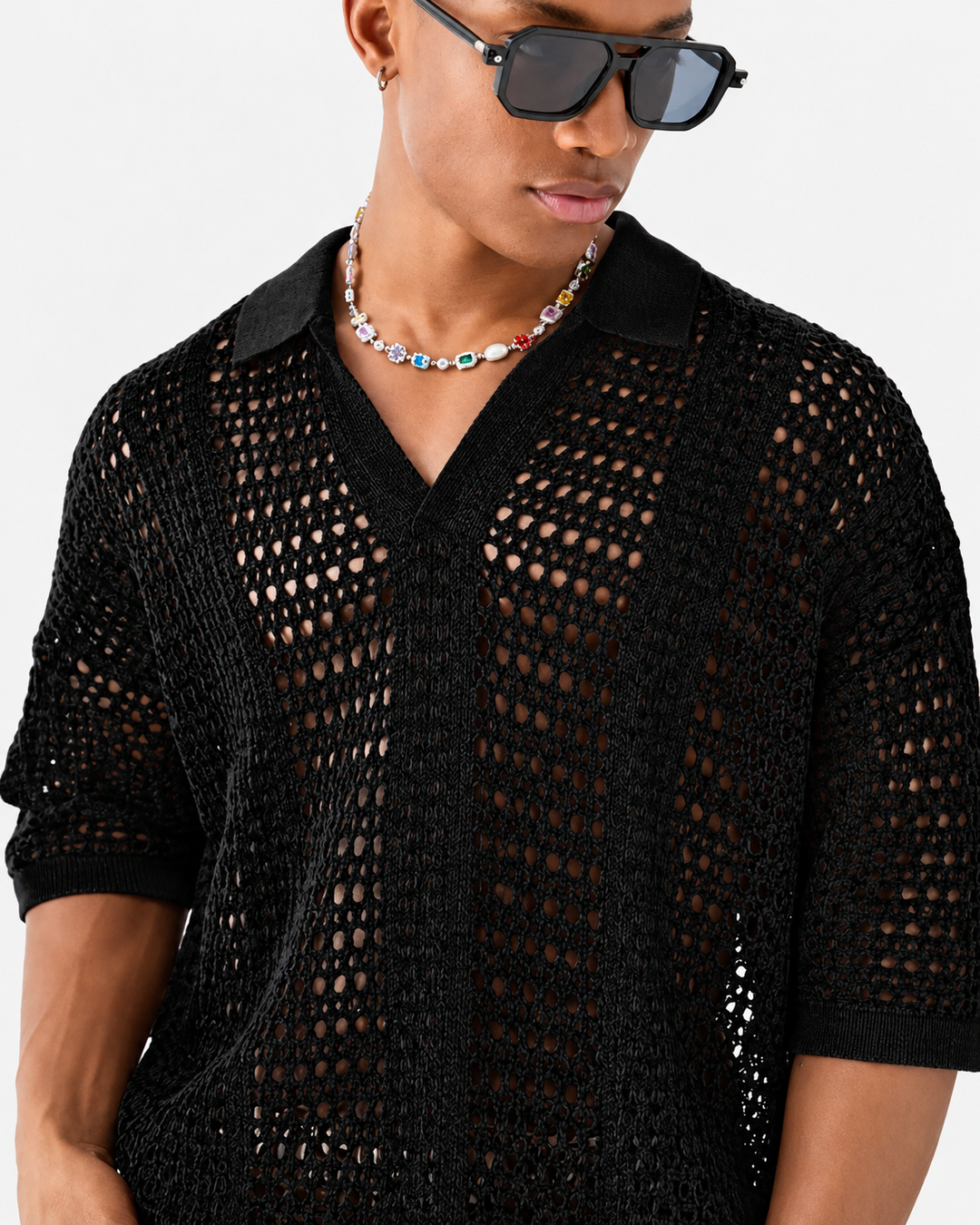 Detail of the ribbed collar on a men's open-knit polo shirt