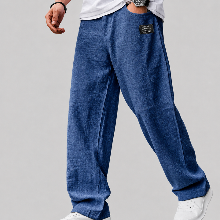 Men's relaxed-fit linen trousers displayed on a model walking