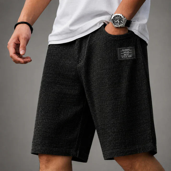 Full view of men's relaxed fit linen shorts on a model