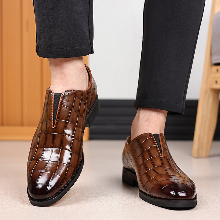 Angled view of men's croc-embossed leather shoes