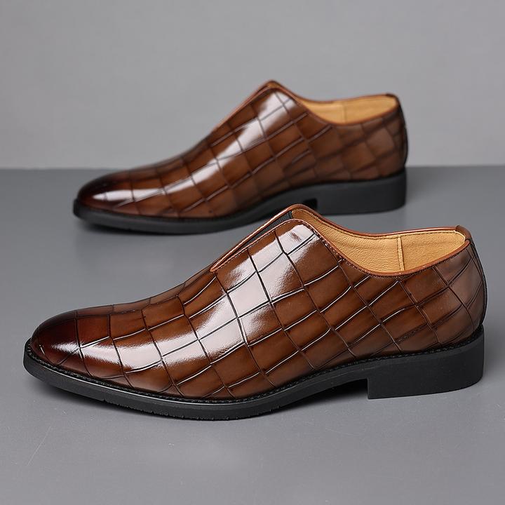 Side view of men's croc-embossed leather loafers