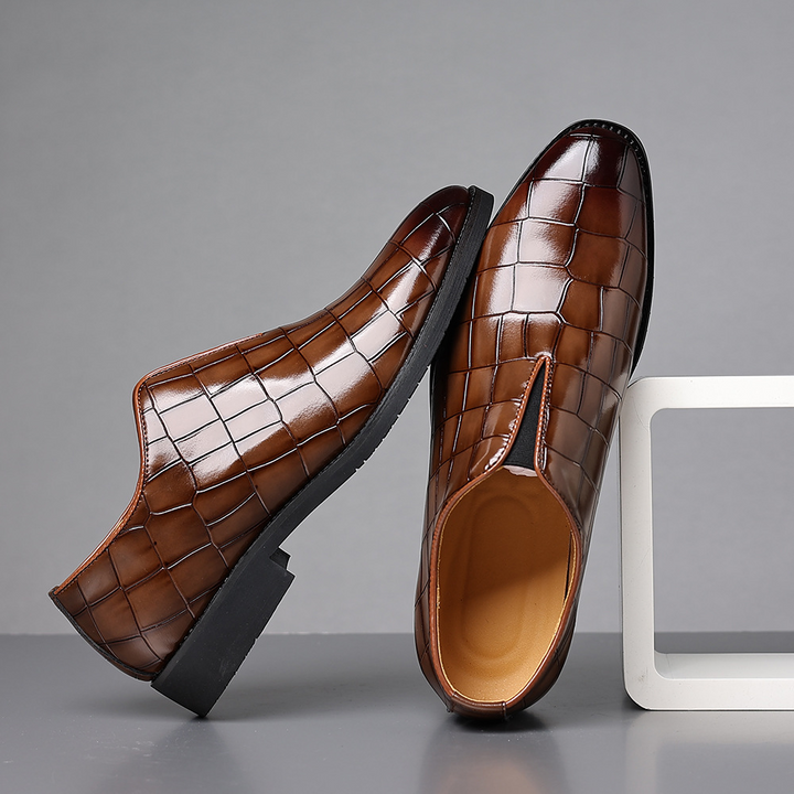 Close-up of the croc-embossed leather texture on loafers