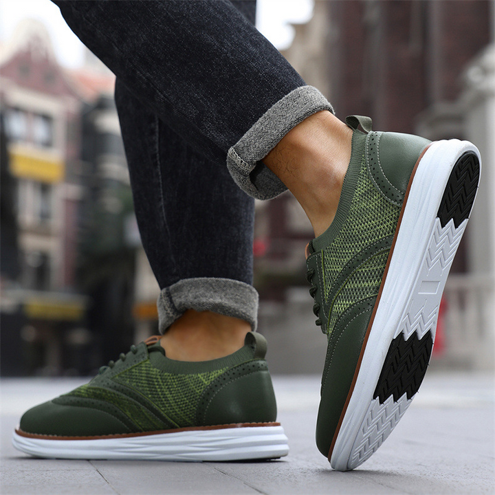 Close-up of men's leather trainers showing breathable mesh and stitching detail
