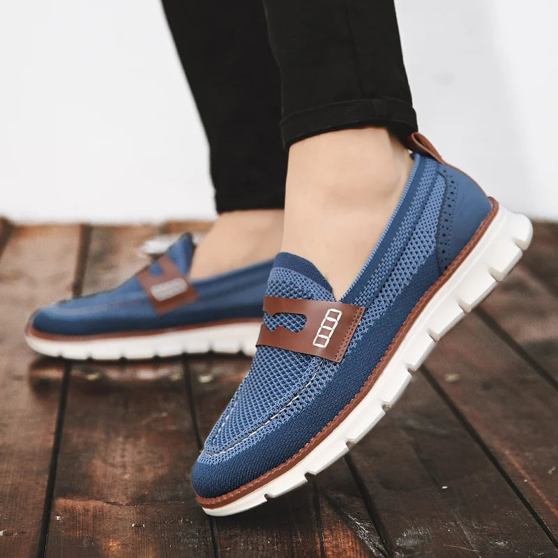 Men's penny loafer showing the textured mesh upper and stitched trim