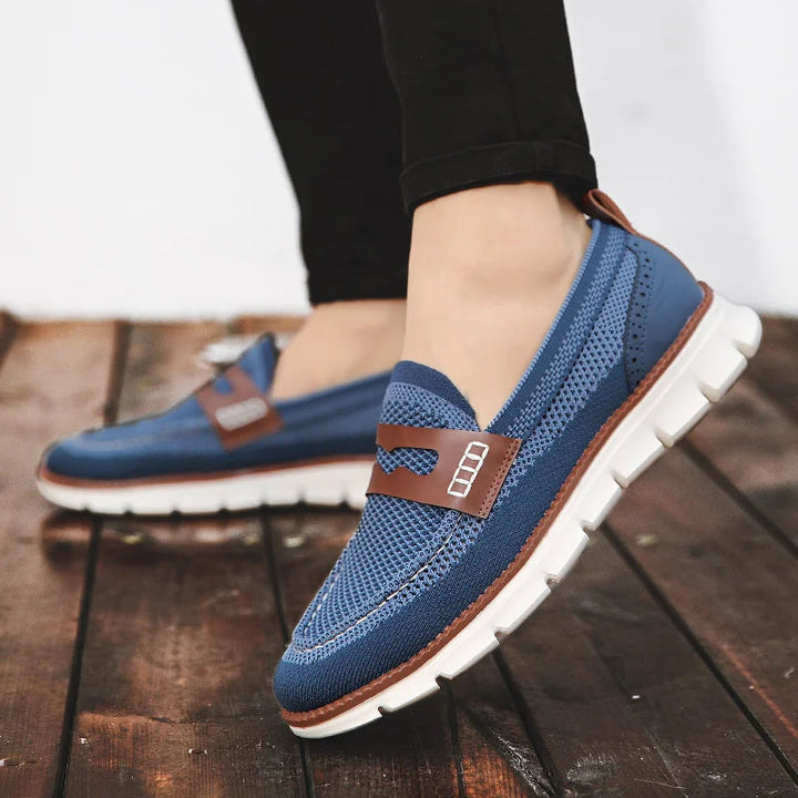 Men's penny loafer showing the textured mesh upper and stitched trim