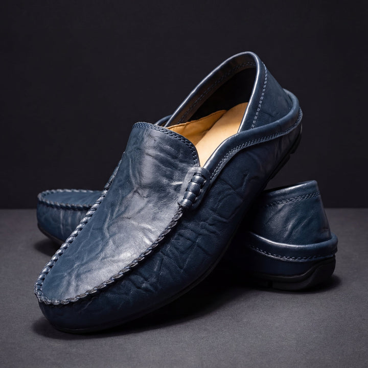 Pair of men's refined slip-on loafers shown from the side