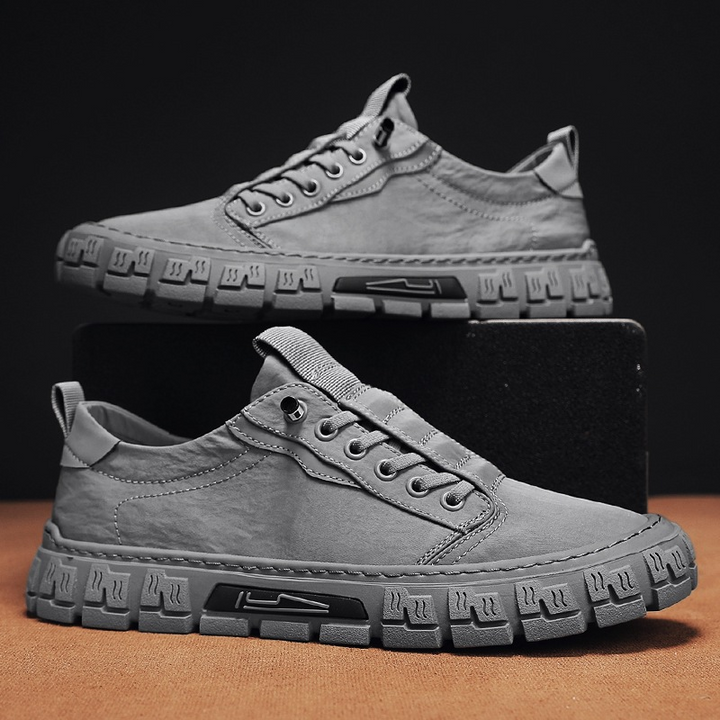Pair of men's canvas trainers with lace-up front and textured sole