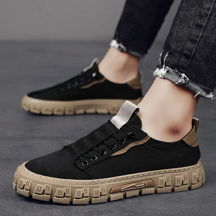 Men's canvas trainers with textured tread sole in a clean product shot