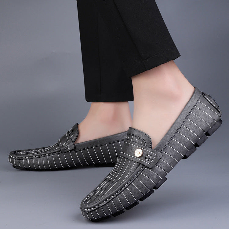 Men's leather loafers with metal detail displayed as a matched pair