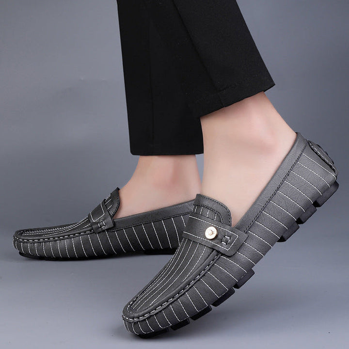 Men's leather loafers with metal detail displayed as a matched pair