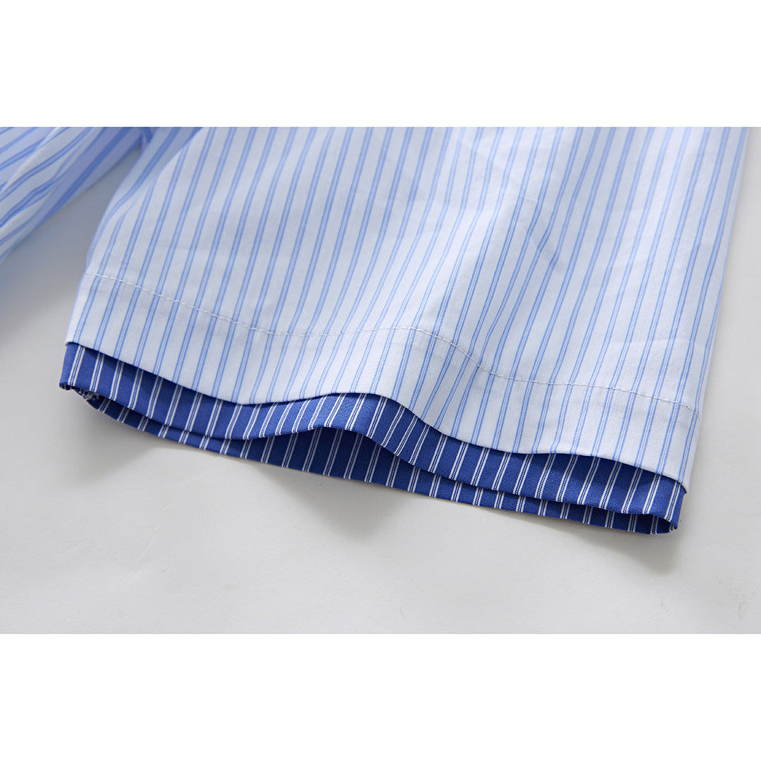 Detail view of hem and fit of men's blue striped short sleeve shirt