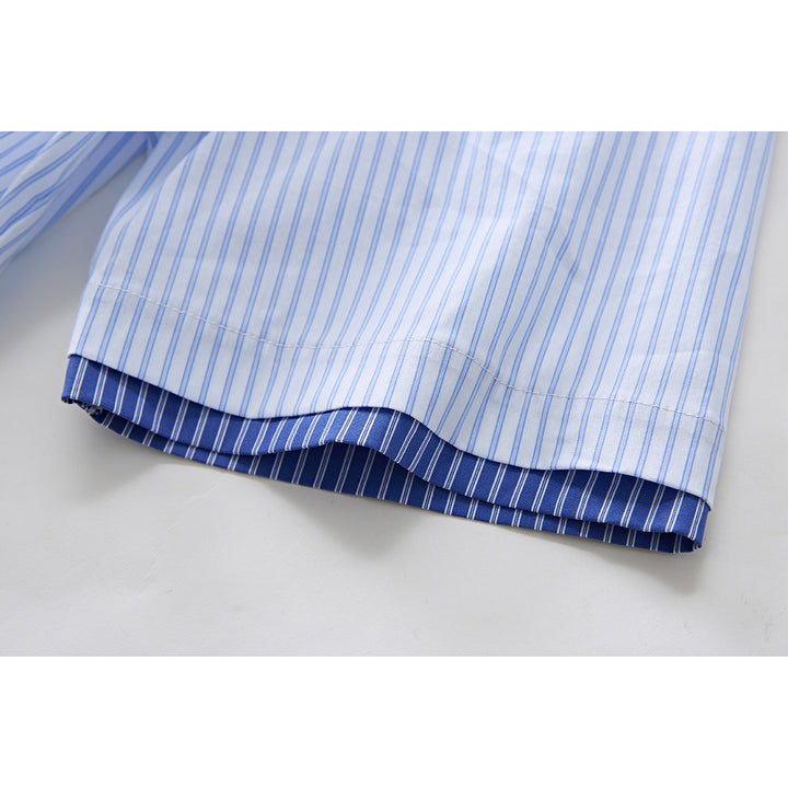 Detail view of hem and fit of men's blue striped short sleeve shirt
