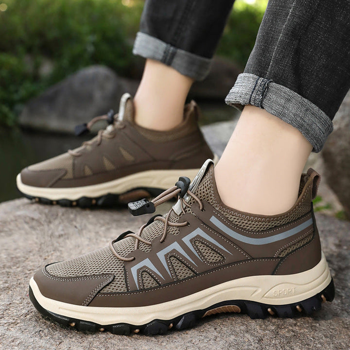 Side view of men's trekking trainers with a supportive sock-like mesh collar