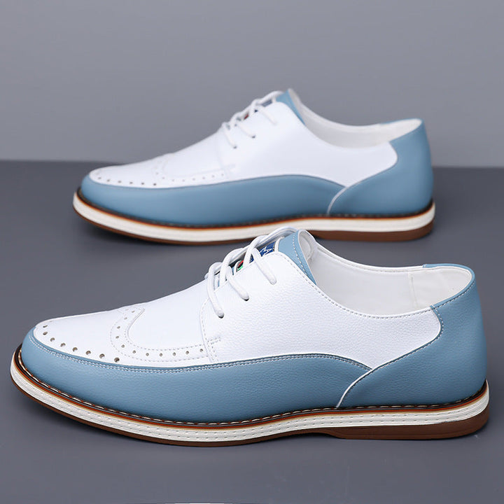 Pair of men's brogue leather shoes displaying elegant two-tone contrast