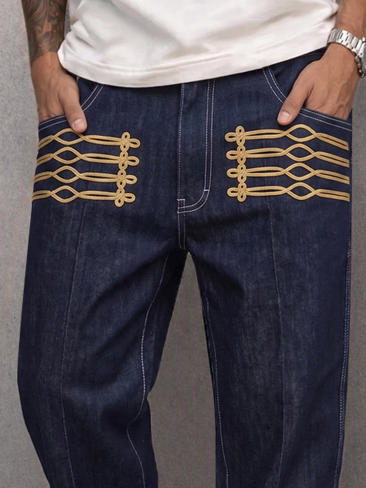 Men's faux denim trousers displaying the waistband and gold frog detail