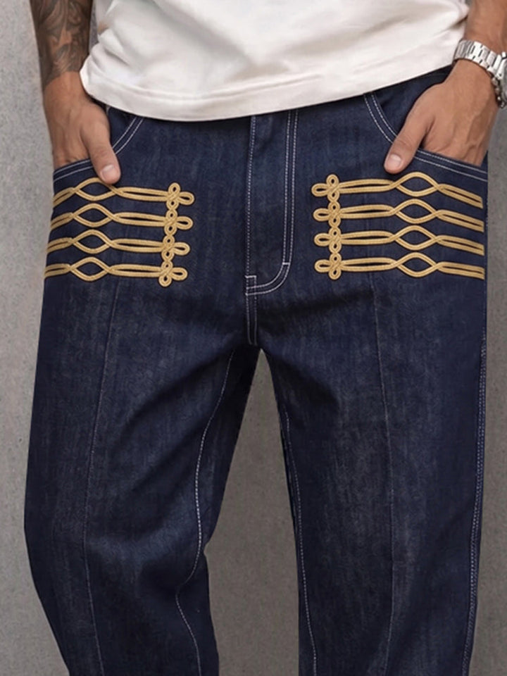 Men's faux denim trousers displaying the waistband and gold frog detail