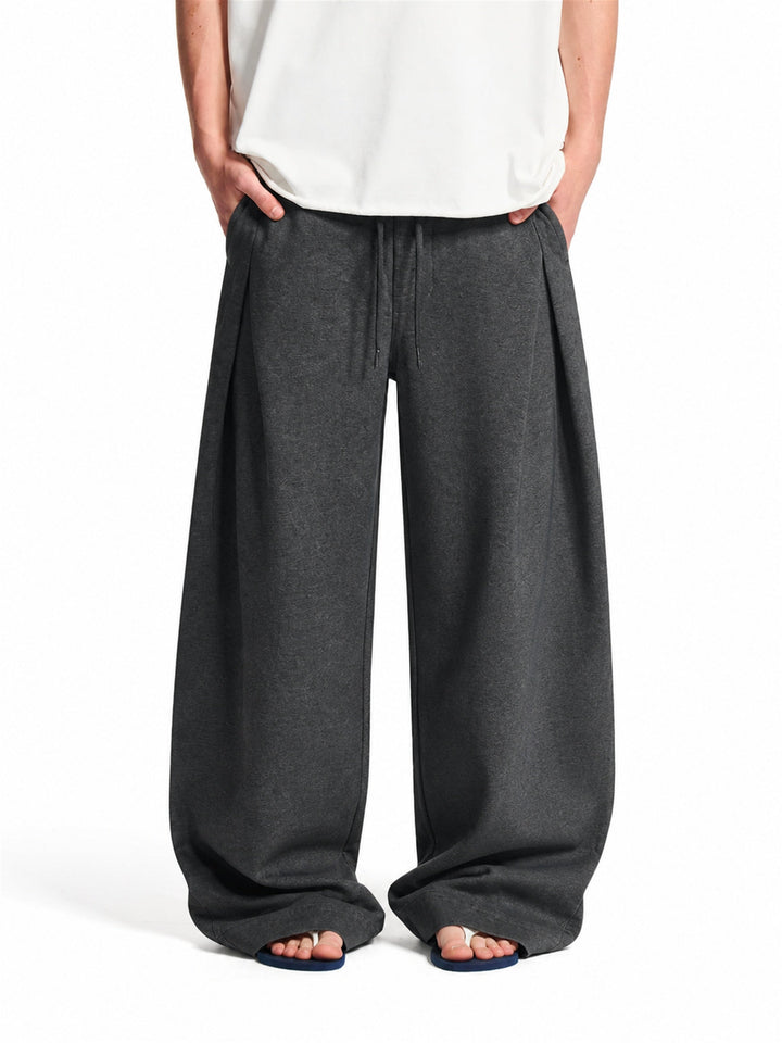Men's pleated baggy joggers showing the relaxed, roomy fit