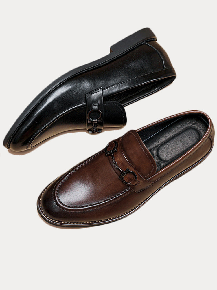 Angled view of men's leather horsebit loafers with polished finish