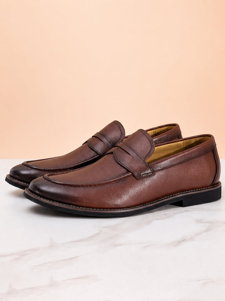 Classic black leather penny loafers for men shown as a pair on white background