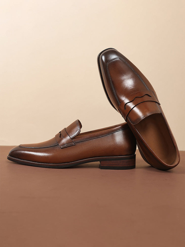 Side profile of men's leather penny loafers with low heel and smooth finish