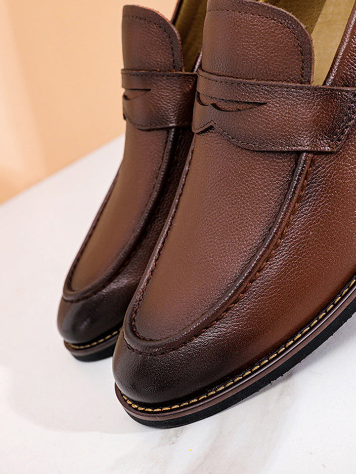 Men's classic penny loafers in leather shown from a three-quarter angle