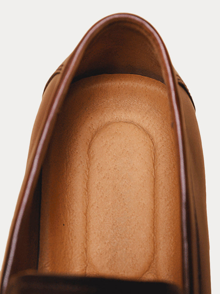 Men's leather penny loafers displayed to show sole and upper construction