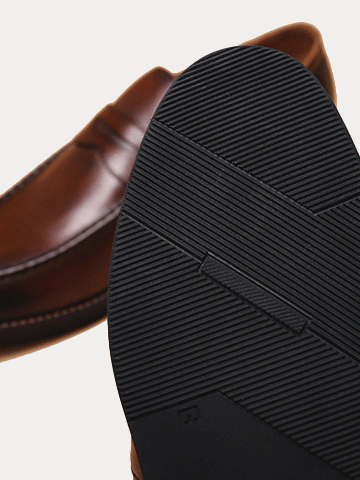 Pair of men's leather penny loafers styled as smart casual slip-on footwear