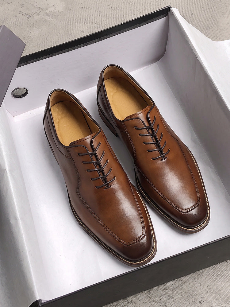 Men's vintage-inspired leather derby shoes displayed as a pair on a white background