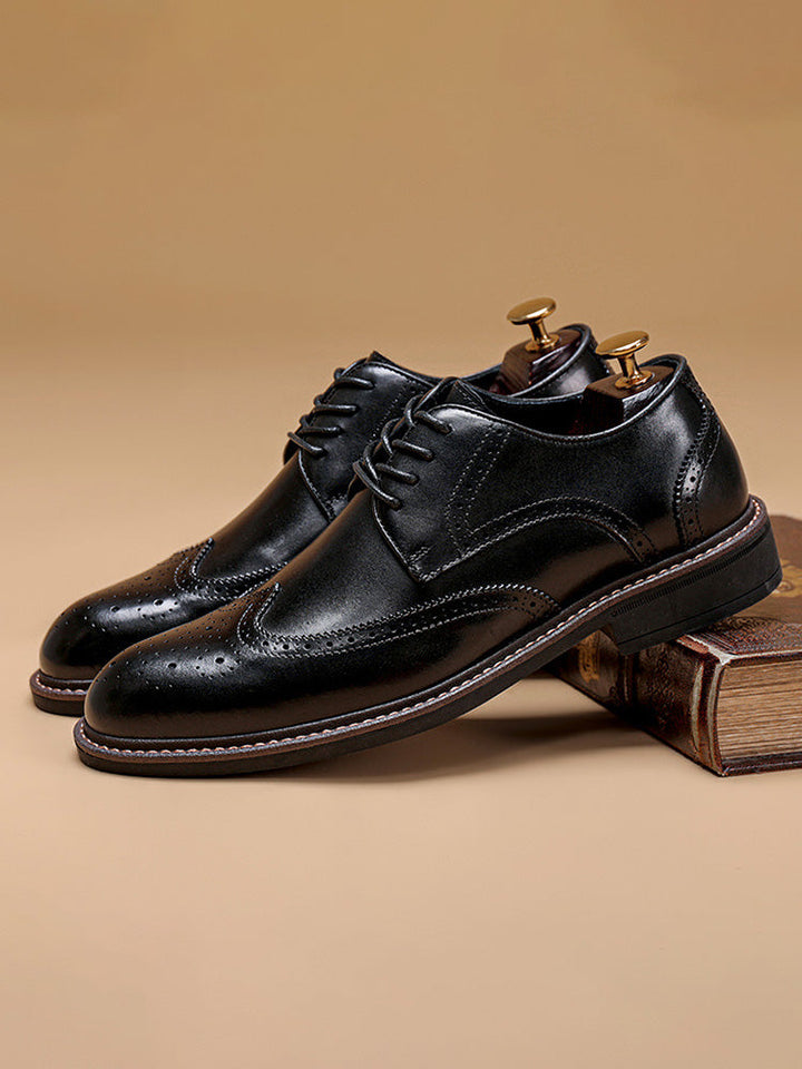 Side view of men's leather wingtip brogue derby shoes with lace-up fastening