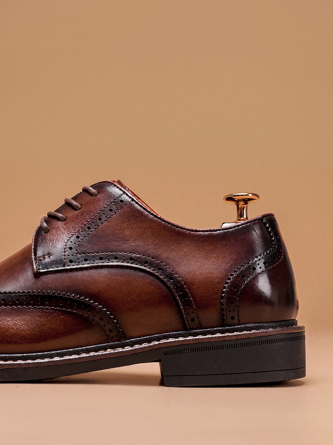 Front view of men's leather wingtip brogue shoes with rounded toe