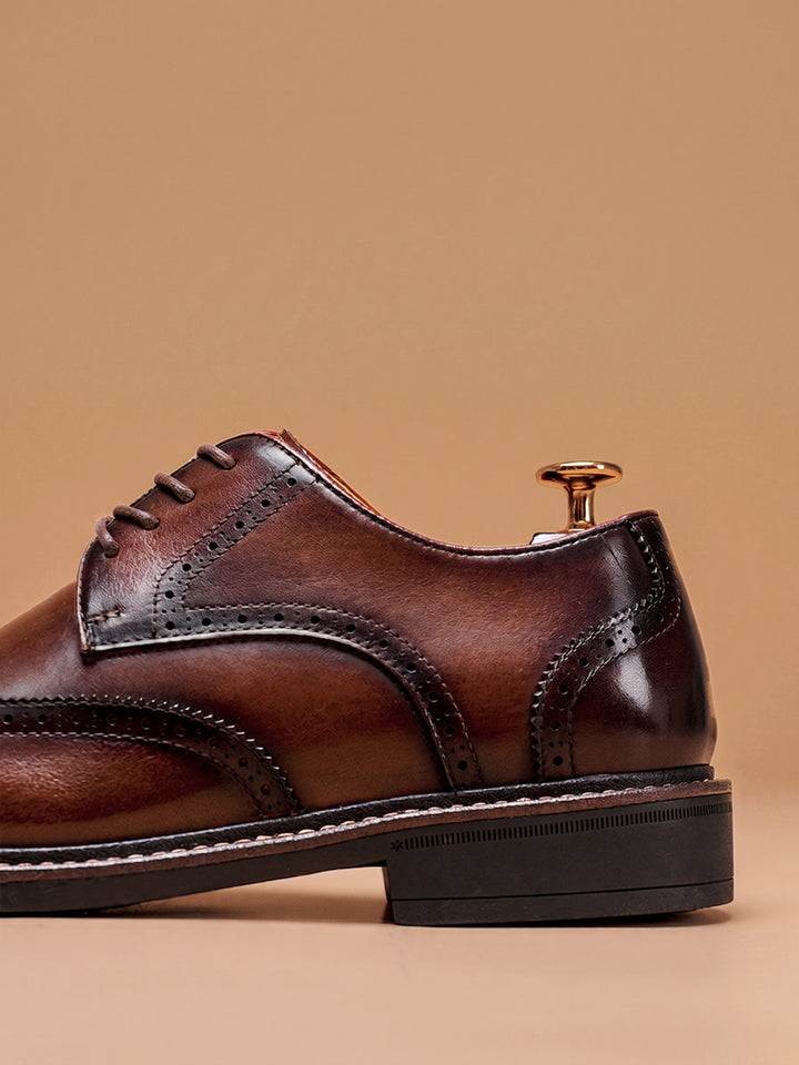 Front view of men's leather wingtip brogue shoes with rounded toe